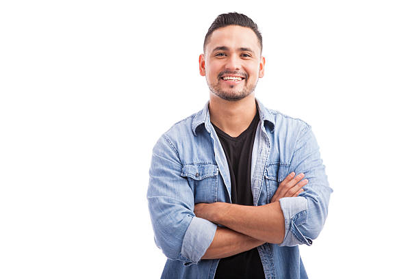 cof2 Handsome young Hispanic guy smiling with his arms crossed against a white background
